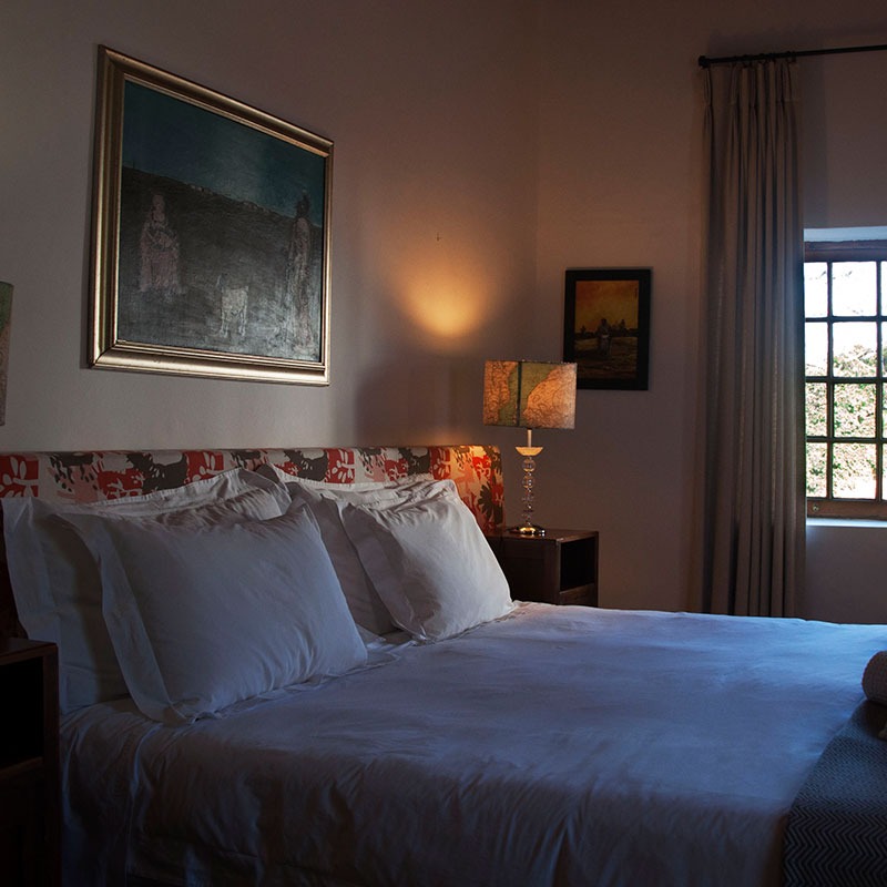 comfortable bed with linen in Art Room bedroom at Wildekrans Country House