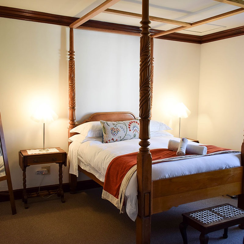 antique four poster bed in Garden View bedroom at Wildekrans Country House