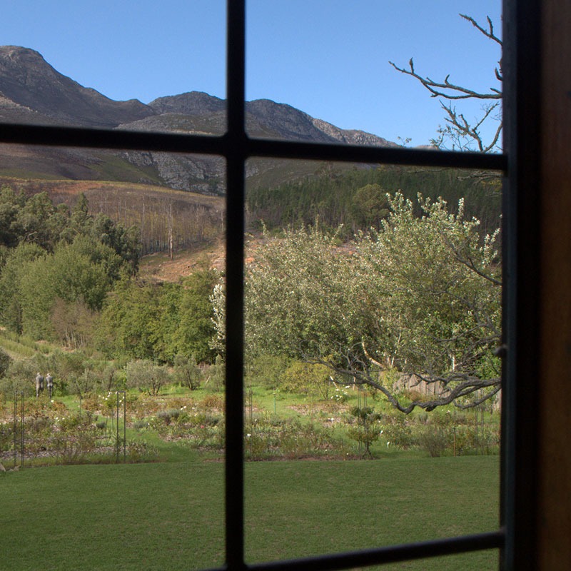 view of the Houw Hoek mountains from the window inside Mountain View bedroom at Wildekrans Country House